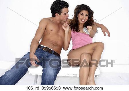 Stock Image - TV, Topless, Television, Technology, Smiling, Shorts, Remote. Fotosearch