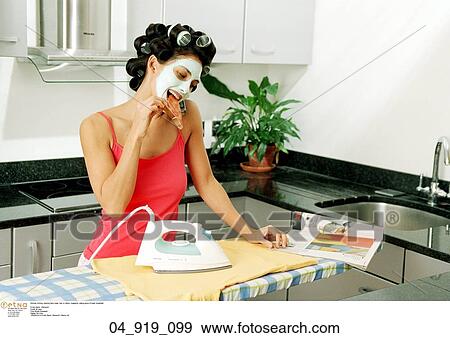 Stock Photo - wearing, face, mask, hair, rollers, magazine. Fotosearch