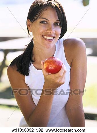 Stock Image - wearing, white, vest, top, eating. Fotosearch