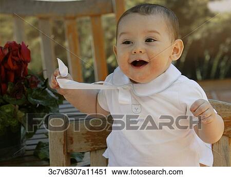 Stock Image - White, shirt, surprised, sunlight, outside, Infant, happy. Fotosearch