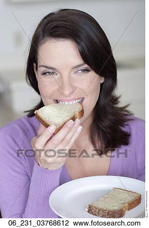 Stock Image - woman, bread, eating. Fotosearch