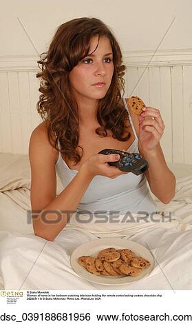 woman, eating, cookie, remote View Large Photo Image Stock Photograph - woman, eating, cookie, remote. Fotosearch