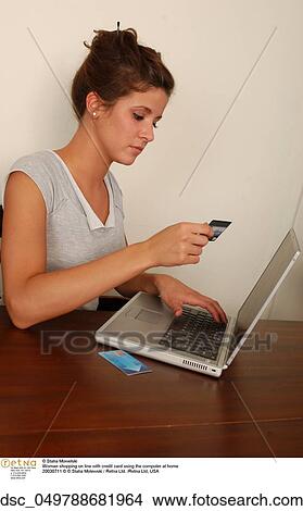 Picture - woman, laptop, credit card. Fotosearch
