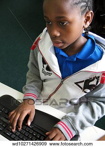Stock Photo - working, computer, afro, caribbean, descent. Fotosearch