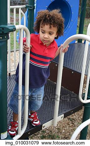 Stock Photo - youth, Stripes, standing, sneakers, playing, playground, Kid. Fotosearch