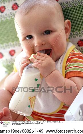 Stock Photo - european descent, bib, Drinking, Child, bottle, 2-18 months. Fotosearch