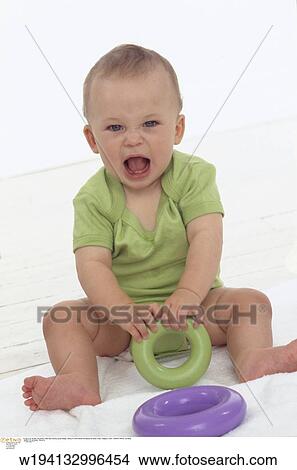 Picture - families, 9 months, vertical image, under 12 months, playing, indoors. Fotosearch