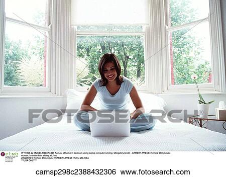 Stock Photograph - Happy, bedroom, Woman. Fotosearch