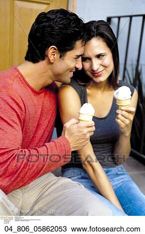 Stock Image - Happy, Woman, Outside, Ice Cream, Couple, At Home. Fotosearch