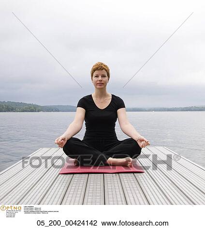 Stock Image - lake meditation, Fitness, Woman, Meditation, Yoga, Exercise, Caucasian. Fotosearch