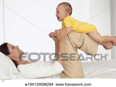 parent and child, families, 9 months, under 35 years, under 12 months, smiling View Large Photo Image Picture - parent and child, families, 9 months, under 35 years, under 12 months, smiling. Fotosearch
