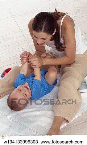 Stock Image - parent and child, families, 9 months, vertical image, under 35 years, under 12 months. Fotosearch