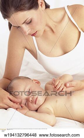 Stock Photo - parent and child, families, 9 months, vertical image, under 35 years, under 12 months. Fotosearch