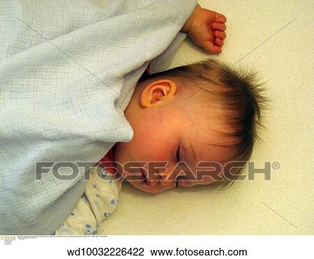 Stock Image - sleeping, vertical image, solo, under 12 months, unsmiling, series, 6-12 months. Fotosearch