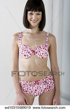 Stock Photo - solo, very happy, vertical image, underwear with strawberry pattern, under 35. Fotosearch