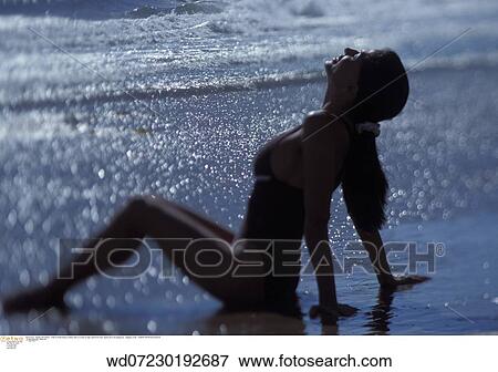 Stock Photo - sparkly sea, under 35, summer, tanned, twenties, abroad. Fotosearch