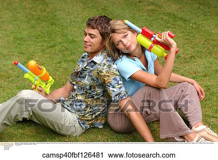 taking a break, weekend, tired out, under 35, water guns, adults with toys View Large Photo Image Stock Image - taking a break, weekend, tired out, under 35, water guns, adults with toys. Fotosearch