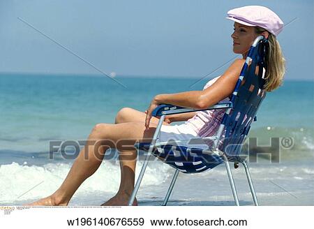 Stock Photo - tanned, under 35, thinking, thirties, thoughtful, summer, abroad. Fotosearch