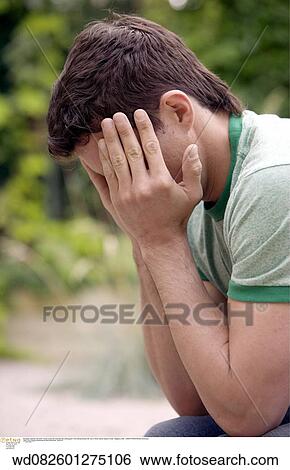 Stock Photograph - upset, unhappy, solo, sideways view. Fotosearch