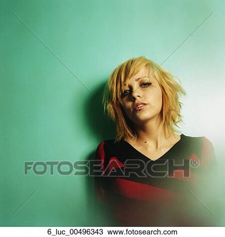 Stock Image - young, woman, wall, against, standing, AlissaTrendy. Fotosearch