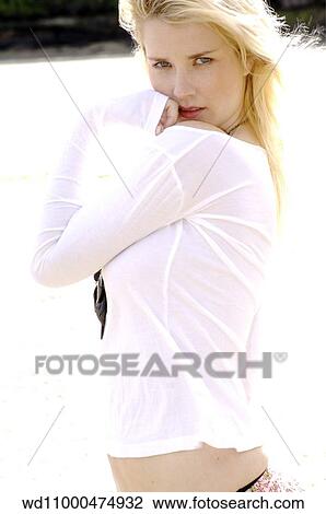 Blonde female wearing a white long sleeved top View Large Photo Image Stock Image - Blonde female wearing a white long sleeved top. Fotosearch