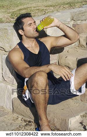 Brunette male wearing a navy blue vest with sweat patch down front and shorts with white trim View Large Photo Image Stock Image - Brunette male wearing a navy blue vest with sweat patch down front and shorts with white trim. Fotosearch