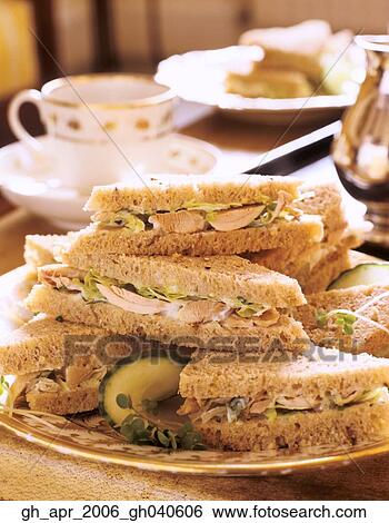 Chicken sandwich with Lemon and tarragon mayo in pile on plate with tea cup in background. View Large Photo Image Stock Photograph - Chicken sandwich with Lemon and tarragon mayo in pile on plate with tea cup in background.. Fotosearch