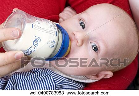 Close up of a baby wearing a blue and white striped jumper being bottle fed View Large Photo Image Stock Image - Close up of a baby wearing a blue and white striped jumper being bottle fed. Fotosearch