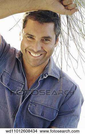 Cropped image of brunette male wearing a blue short sleeved shirt View Large Photo Image Picture - Cropped image of brunette male wearing a blue short sleeved shirt. Fotosearch
