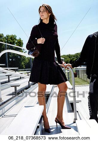fashion outside thinking black dress purse handbag high heels standing man holding hands woman portrait View Large Photo Image Stock Image - fashion outside thinking black dress purse handbag high heels standing man holding hands woman portrait. Fotosearch