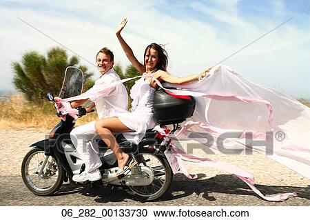 Full length side view of a bride looking at the camera waving from the back of a scooter with her veil blowing behind her in the wind View Large Photo Image Stock Image - Full length side view of a bride looking at the camera waving from the back of a scooter with her veil blowing behind her in the wind. Fotosearch