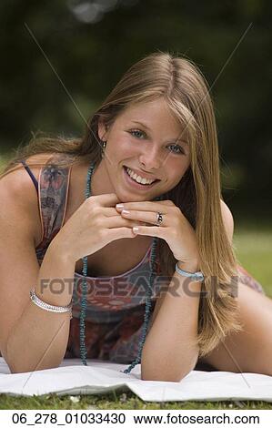 Half length front view young woman long blonde hair leaning forward on elbows looking at camera smiling View Large Photo Image Stock Image - Half length front view young woman long blonde hair leaning forward on elbows looking at camera smiling. Fotosearch