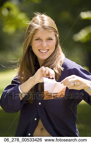 Half length front view young woman long blonde hair looking at camera ripping a burnt letter View Large Photo Image Stock Photograph - Half length front view young woman long blonde hair looking at camera ripping a burnt letter. Fotosearch