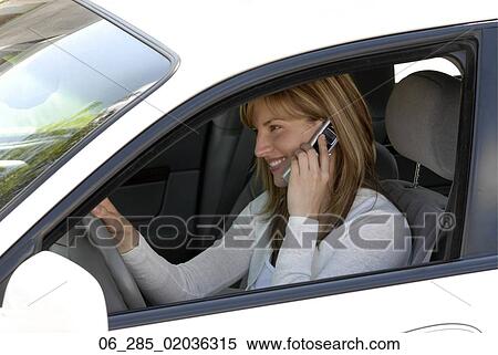 Head and shoulders side view woman in drivers seat of a car talking on a mobile phone View Large Photo Image Stock Photography - Head and shoulders side view woman in drivers seat of a car talking on a mobile phone. Fotosearch