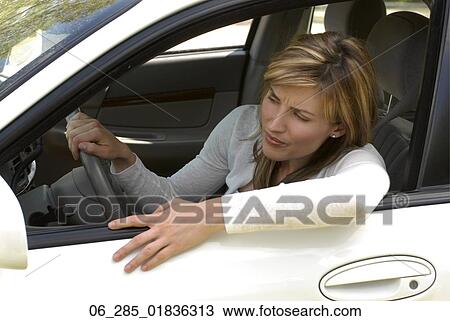 Head and shoulders side view woman sitting in traffic jam leaning out of drivers window View Large Photo Image Stock Image - Head and shoulders side view woman sitting in traffic jam leaning out of drivers window. Fotosearch