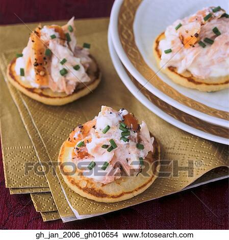 Picture - hot smoked salmon blinis. Fotosearch