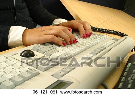 Stock Image - keyboard inside typing hands nails red woman working work desk business office. Fotosearch