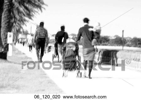 Stock Image - Melbourne beach summer St. Kilda people walking path families family couple. Fotosearch