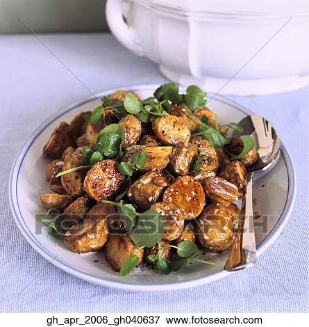Roast new potatoes with rocket on top on plate with spoon on the side. View Large Photo Image Stock Photo - Roast new potatoes with rocket on top on plate with spoon on the side.. Fotosearch
