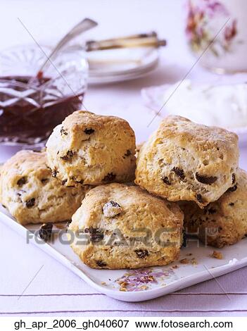 Scones on white plate wit glass pot of jam in the background. View Large Photo Image Stock Photo - Scones on white plate wit glass pot of jam in the background.. Fotosearch