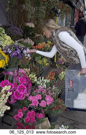 woman outside 20's 30's thinking decision walking standing flowers shop shopping florist choice choose buy bunch jeans vest fake fur faux View Large Photo Image Stock Image - woman outside 20's 30's thinking decision walking standing flowers shop shopping florist choice choose buy bunch jeans vest fake fur faux. Fotosearch