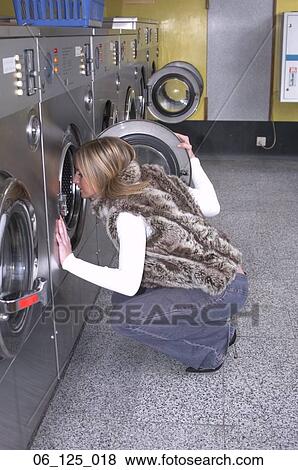 woman outside 20's 30's thinking decision kneeling blond hair faux fur jeans high heals laundry mat laundrette washing machine tumble dryer look inside lost View Large Photo Image Stock Photo - woman outside 20's 30's thinking decision kneeling blond hair faux fur jeans high heals laundry mat laundrette washing machine tumble dryer look inside lost. Fotosearch