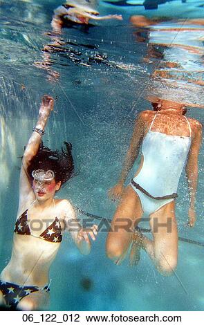 Stock Image - woman swimming bathing suit summer outside smile happt water fun game playing underwater bakini teenager teen swim pool. Fotosearch