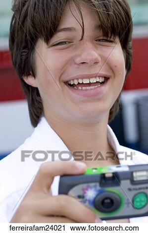 A teenage boy taking pictures with a disposable camera View Large Photo Image Stock Image - A teenage boy taking pictures with a disposable camera. Fotosearch