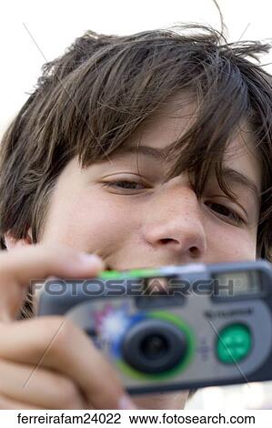 A teenage boy taking pictures with a disposable camera View Large Photo Image Stock Image - A teenage boy taking pictures with a disposable camera. Fotosearch