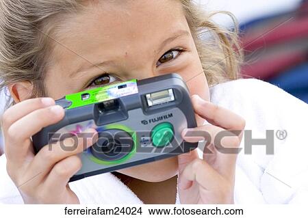 A young girl taking pictures with a disposable camera View Large Photo Image Picture - A young girl taking pictures with a disposable camera. Fotosearch