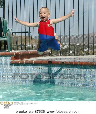 African American boy jumping into a swimming pool having fun View Large Photo Image Stock Photograph - African American boy jumping into a swimming pool having fun. Fotosearch