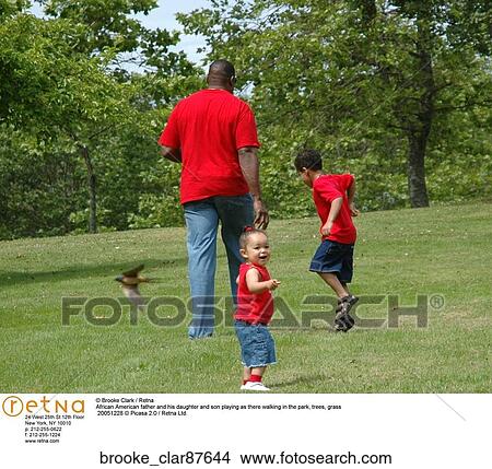 African American father and his daughter and son playing as there walking in the park View Large Photo Image Picture - African American father and his daughter and son playing as there walking in the park. Fotosearch