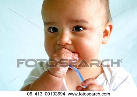BabyShot of one year old baby boy playing with his first toothbrush View Large Photo Image Picture - BabyShot of one year old baby boy playing with his first toothbrush . Fotosearch