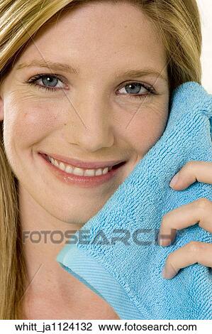 Blonde woman in her 20's holds a blue towel to her face. View Large Photo Image Stock Image - Blonde woman in her 20's holds a blue towel to her face.. Fotosearch